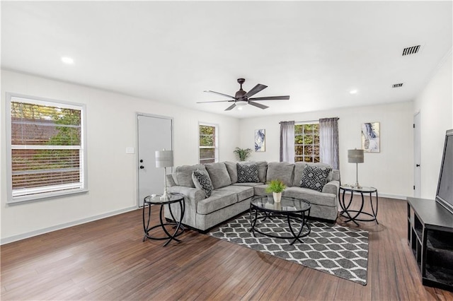 living room featuring plenty of natural light, dark hardwood / wood-style floors, and ceiling fan