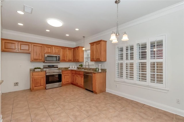 kitchen featuring brown cabinets, appliances with stainless steel finishes, crown molding, and a sink