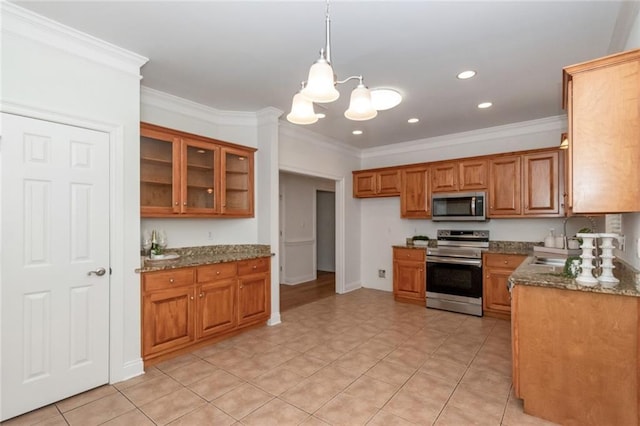 kitchen featuring brown cabinetry, appliances with stainless steel finishes, and ornamental molding