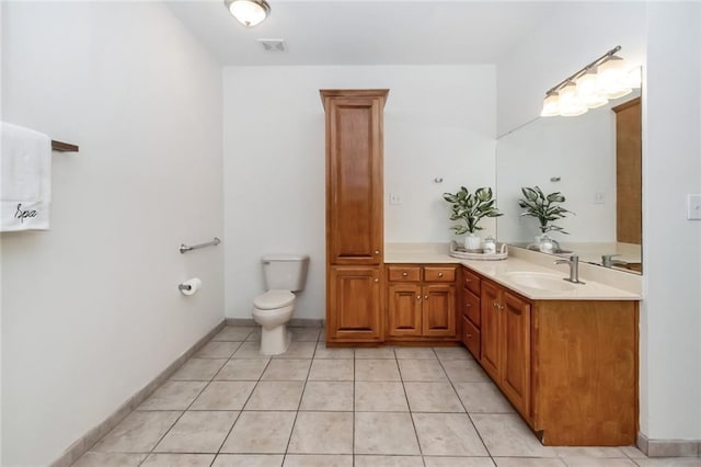 bathroom with visible vents, baseboards, toilet, tile patterned floors, and vanity