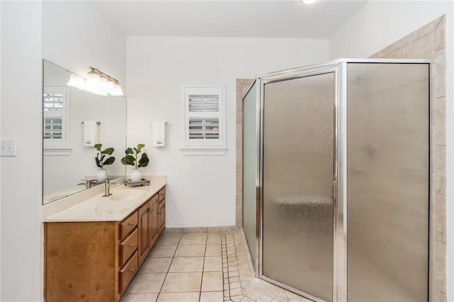 bathroom with a stall shower, vanity, and tile patterned flooring