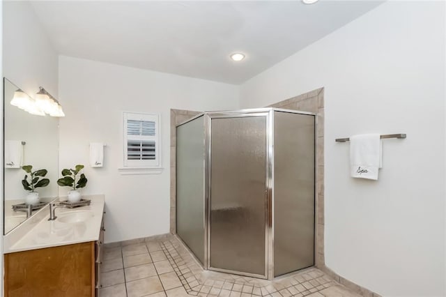 full bathroom with tile patterned floors, a shower stall, vanity, and baseboards