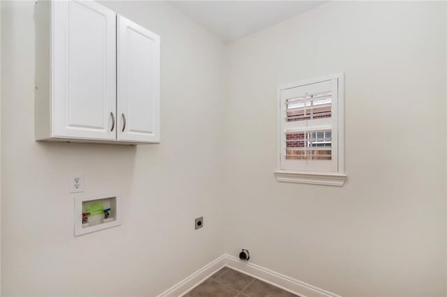 washroom featuring baseboards, washer hookup, cabinet space, hookup for an electric dryer, and dark tile patterned flooring