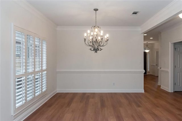 unfurnished dining area featuring visible vents, wood finished floors, and crown molding