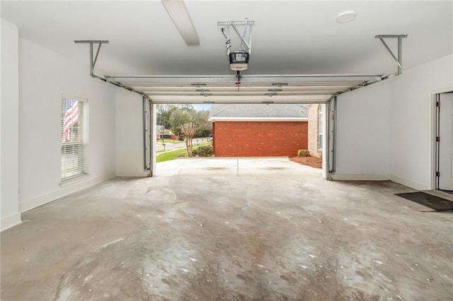 garage featuring a garage door opener and baseboards