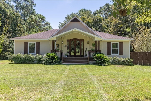 ranch-style house featuring a front yard, french doors, and a porch