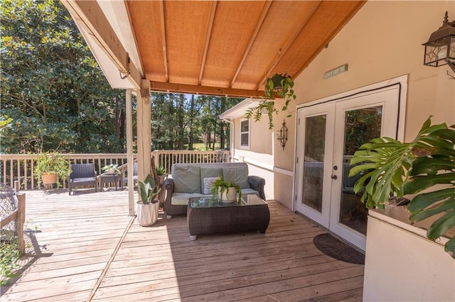 wooden deck featuring an outdoor living space and french doors