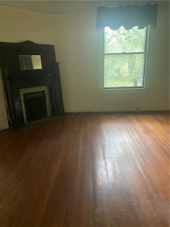1902 Calmes St, Mobile, AL 36606 - unfurnished living room with wood-type flooring and a fireplace