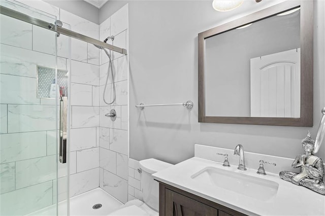 bathroom featuring vanity, an enclosed shower, and toilet