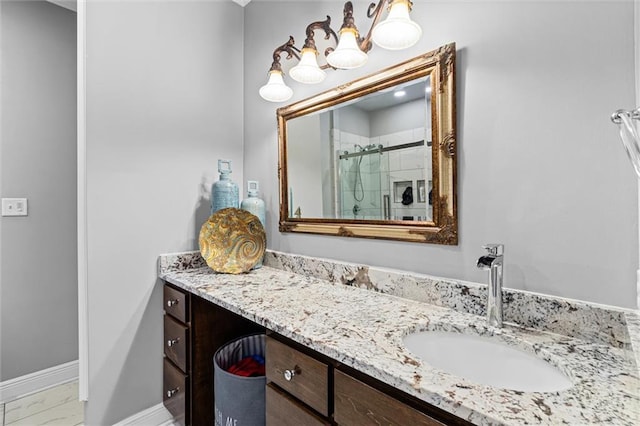 bathroom with a shower with door and vanity