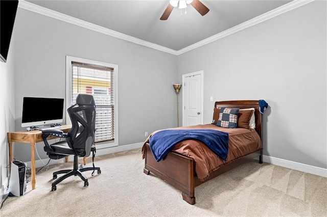 carpeted bedroom with ornamental molding and ceiling fan