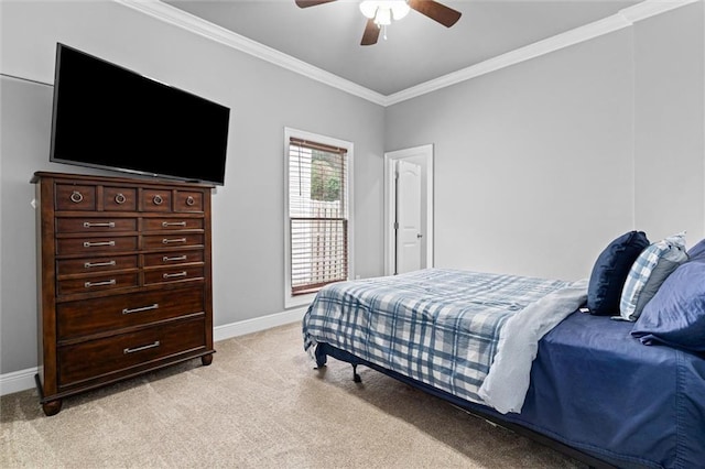 carpeted bedroom featuring ornamental molding and ceiling fan