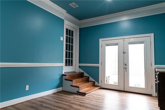 entryway featuring crown molding, light wood-type flooring, and french doors