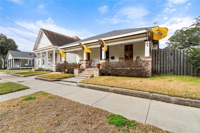 view of front of home featuring a front lawn and a porch