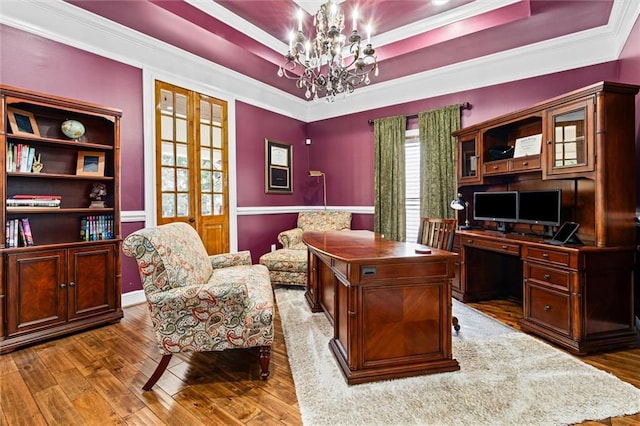 office space featuring french doors, crown molding, a chandelier, dark hardwood / wood-style floors, and a tray ceiling