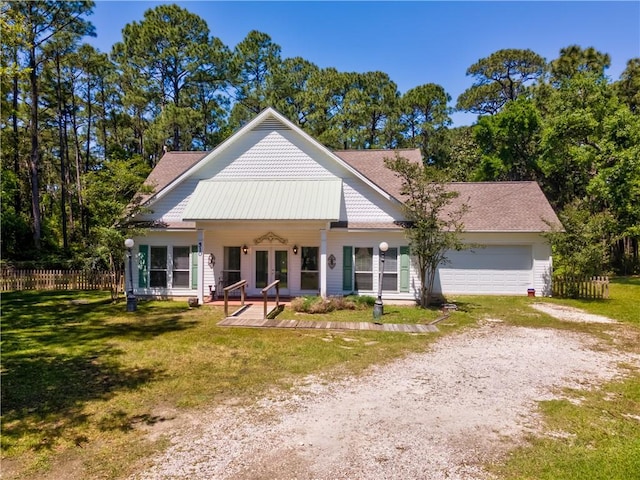 510 Fort Mims Pl, Dauphin Island, AL 36528 - view of front of house featuring a garage, fence, a front lawn, french doors, and driveway