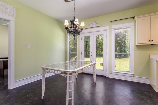 510 Fort Mims Pl, Dauphin Island, AL 36528 - dining room with french doors, baseboards, and an inviting chandelier