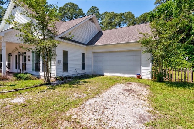 510 Fort Mims Pl, Dauphin Island, AL 36528 - view of front of property featuring dirt driveway, roof with shingles, a front yard, fence, and an attached garage