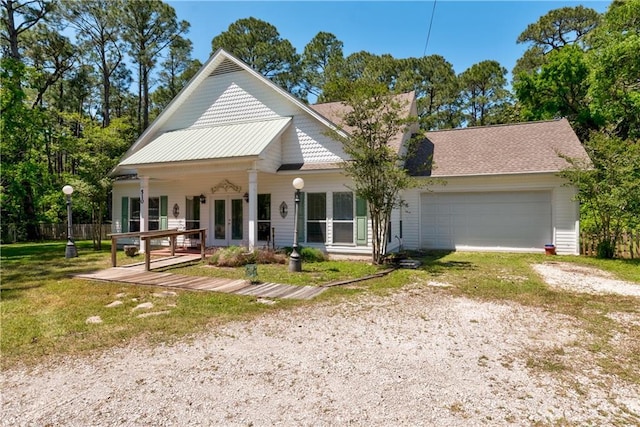 510 Fort Mims Pl, Dauphin Island, AL 36528 - view of front facade with an attached garage, french doors, a front yard, and dirt driveway