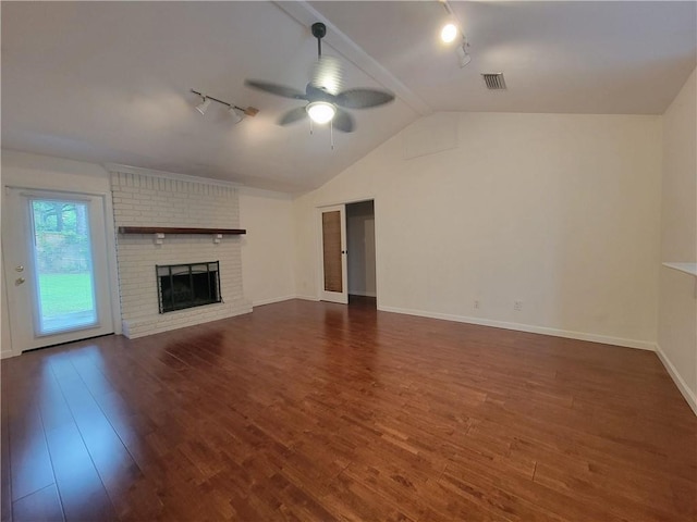 2544 Buckboard Ct, Mobile, AL 36695 - unfurnished living room with rail lighting, ceiling fan, lofted ceiling, dark wood finished floors, and a fireplace
