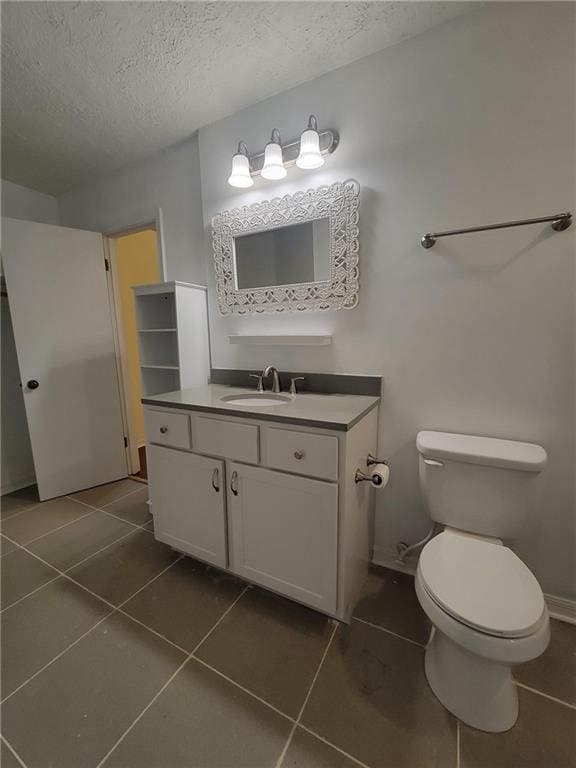 2544 Buckboard Ct, Mobile, AL 36695 - bathroom featuring a textured ceiling, tile patterned floors, vanity, and toilet