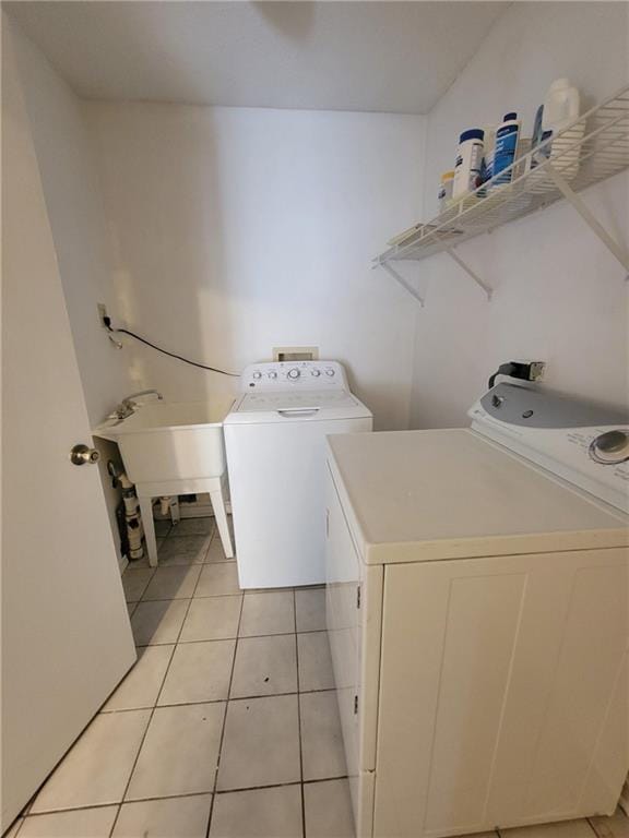 2544 Buckboard Ct, Mobile, AL 36695 - laundry room featuring washing machine and dryer and light tile patterned floors