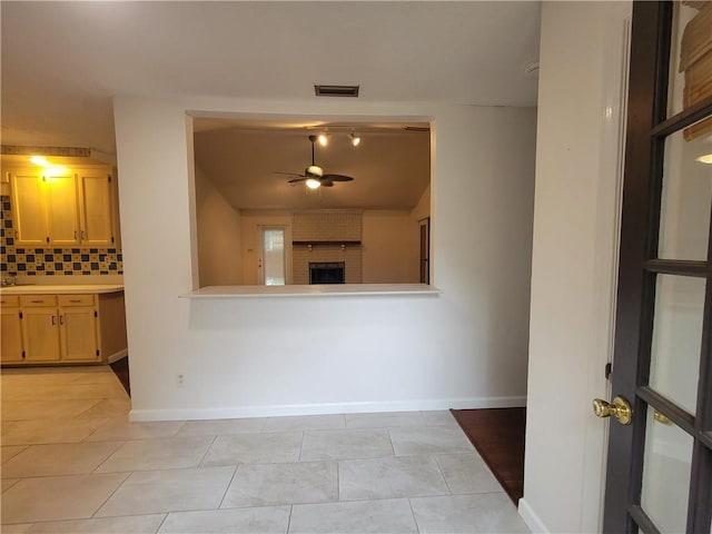 2544 Buckboard Ct, Mobile, AL 36695 - unfurnished living room featuring ceiling fan, baseboards, a brick fireplace, and light tile patterned floors