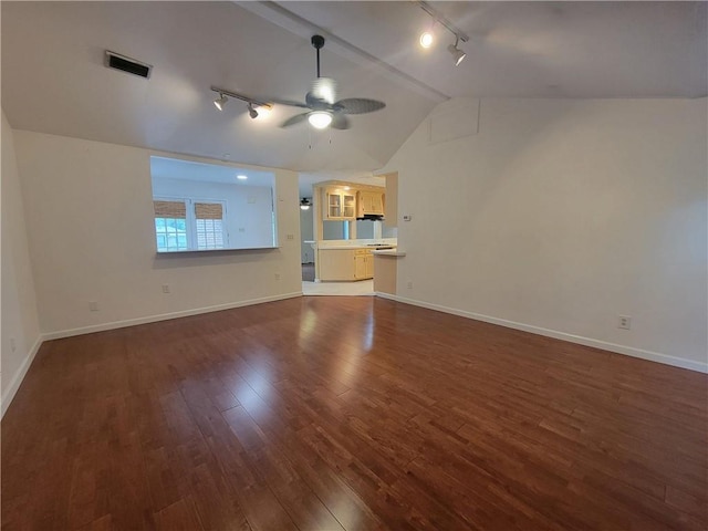 2544 Buckboard Ct, Mobile, AL 36695 - unfurnished living room with rail lighting, vaulted ceiling, dark wood-type flooring, ceiling fan, and baseboards