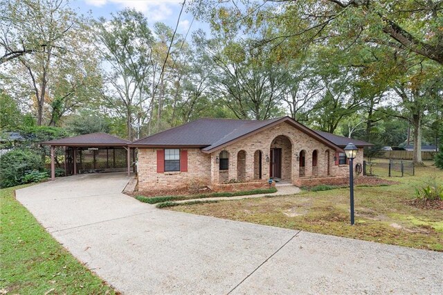 single story home featuring a carport and a front lawn