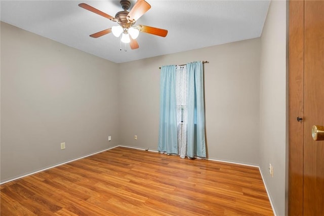 unfurnished room with ceiling fan and light wood-type flooring