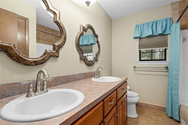 bathroom with tile patterned floors, vanity, curtained shower, and toilet