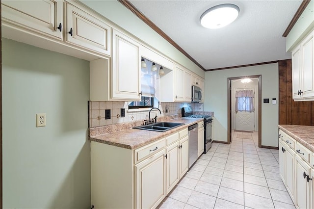 kitchen with appliances with stainless steel finishes, backsplash, crown molding, sink, and light tile patterned floors