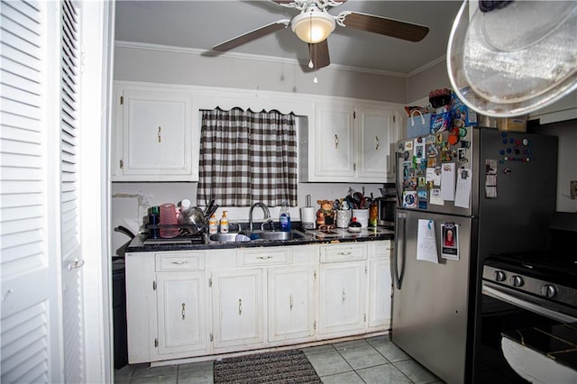 612 Summerland Dr, Mobile, AL 36617 - kitchen with gas range, ceiling fan, a sink, white cabinetry, and light tile patterned floors