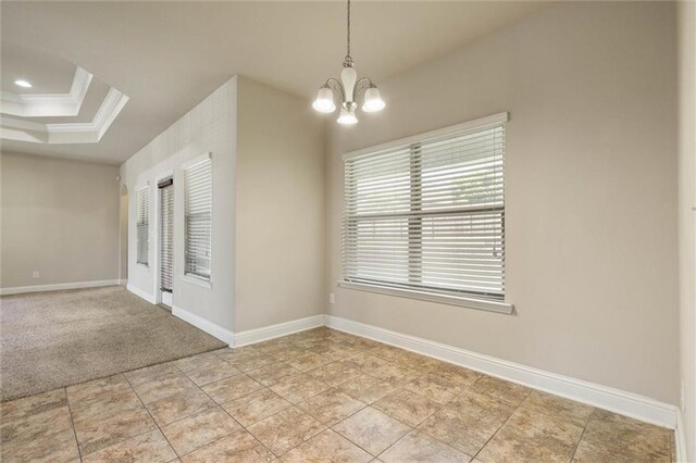 2151 Elliott Ct, Mobile, AL 36695 - empty room featuring a chandelier, baseboards, crown molding, a tray ceiling, and light tile patterned floors