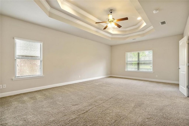 2151 Elliott Ct, Mobile, AL 36695 - empty room featuring a tray ceiling, ornamental molding, ceiling fan, light colored carpet, and baseboards