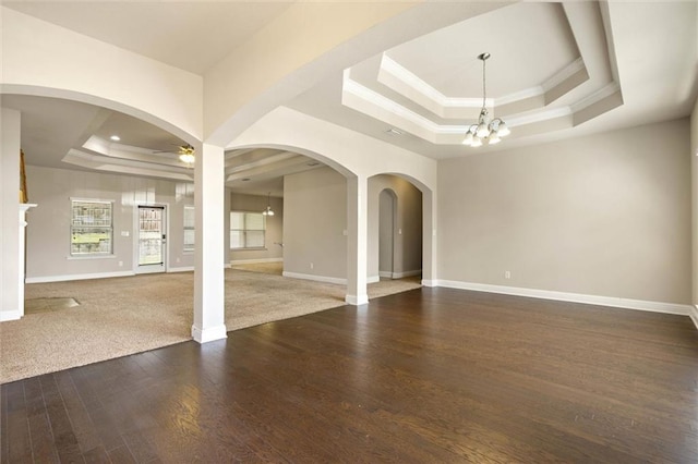 2151 Elliott Ct, Mobile, AL 36695 - spare room featuring a tray ceiling, a chandelier, a ceiling fan, crown molding, and wood finished floors