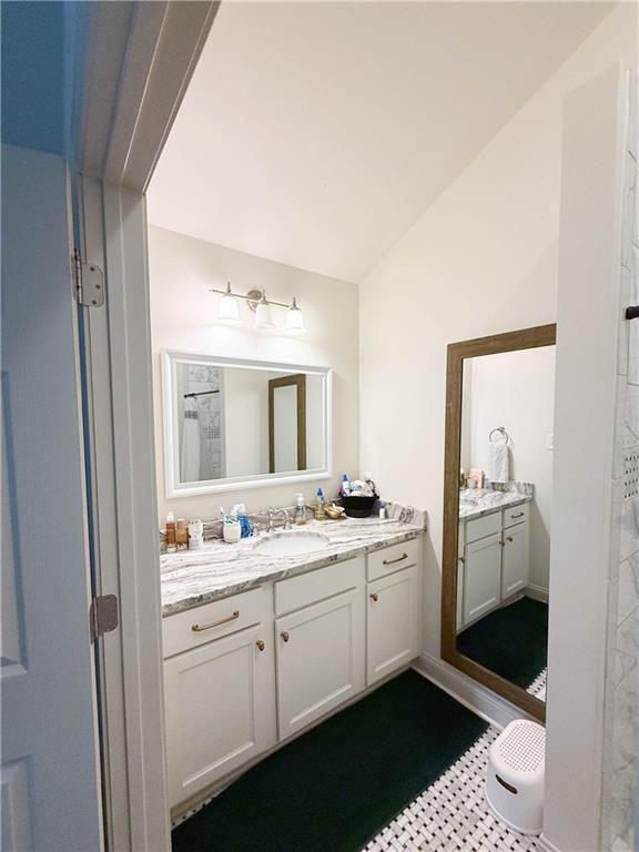 2555 E Rd, Mobile, AL 36693 - full bathroom featuring vanity and lofted ceiling