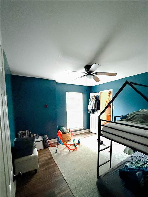 2555 E Rd, Mobile, AL 36693 - bedroom with wood finished floors, a ceiling fan, and baseboards