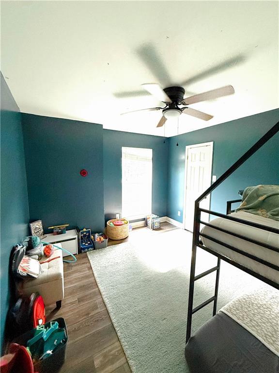 2555 E Rd, Mobile, AL 36693 - bedroom featuring wood finished floors and a ceiling fan