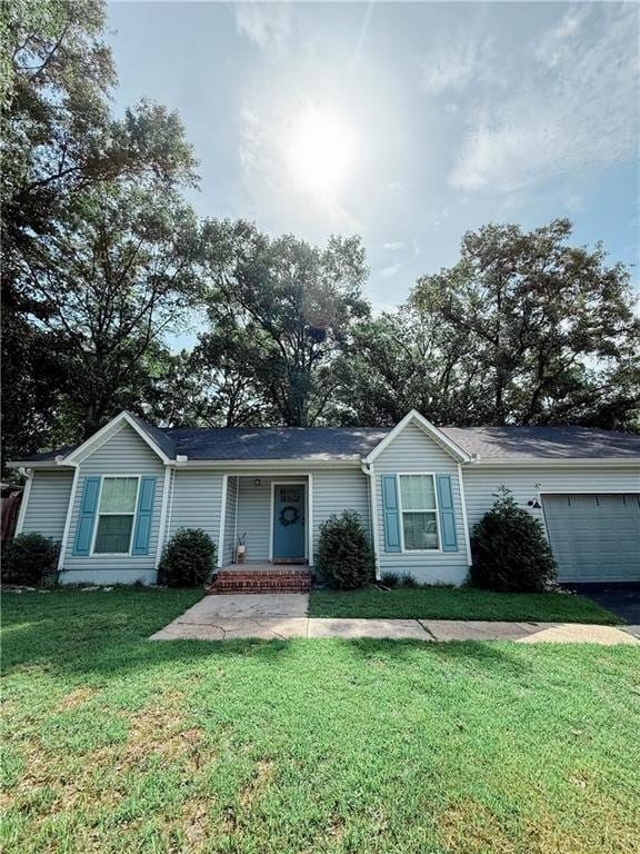 2555 E Rd, Mobile, AL 36693 - ranch-style home featuring a front yard and an attached garage