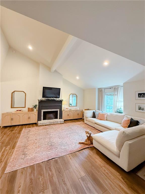 2555 E Rd, Mobile, AL 36693 - living area featuring light wood-style flooring, a brick fireplace, and recessed lighting