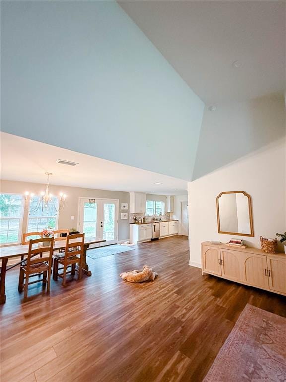 2555 E Rd, Mobile, AL 36693 - living room featuring high vaulted ceiling, a chandelier, and wood finished floors