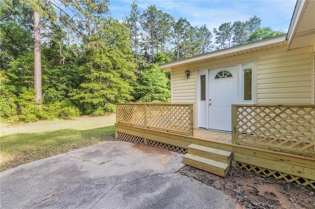 property entrance with a patio area and a deck
