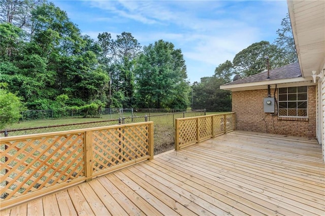wooden deck featuring a lawn and a fenced backyard