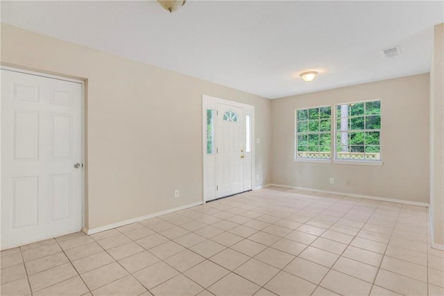 unfurnished room with light tile patterned floors, baseboards, and visible vents