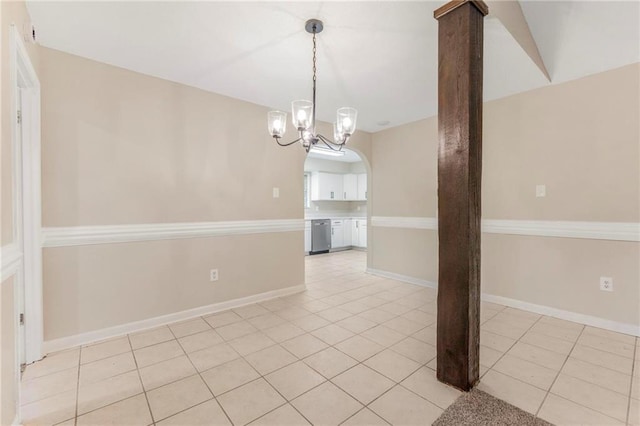 unfurnished dining area featuring light tile patterned floors, baseboards, and a notable chandelier