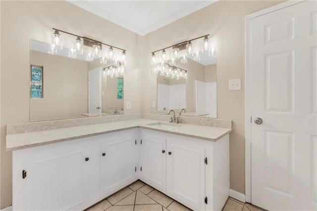 full bath featuring a sink, tile patterned floors, and double vanity