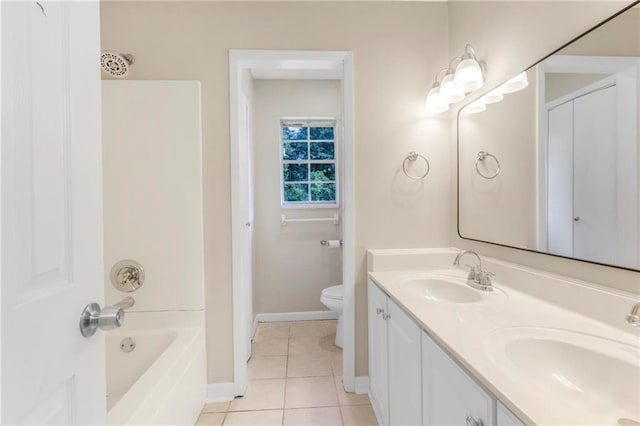bathroom featuring tile patterned flooring, a sink, baseboards, and toilet