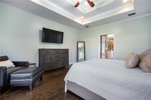 bedroom with dark wood-type flooring, ensuite bathroom, ceiling fan, ornamental molding, and a tray ceiling