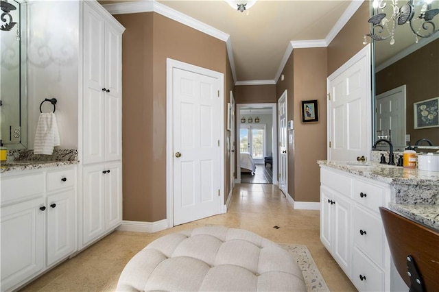 bathroom featuring tile patterned flooring, vanity, and crown molding